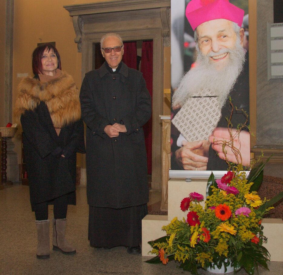 Monsignor Cresseri tra la presidente degli Amici Rosanna Pirovano e l'immagine di padre Aristide alla Messa nell'anniversario della morte nel 2020